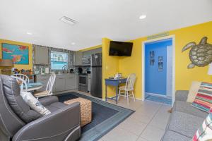 a living room with a couch and a kitchen at Turtle Cay in Englewood
