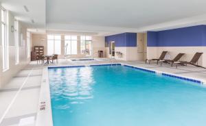 a large pool with blue water in a hotel room at Hyatt Place Canton in Lake Cable