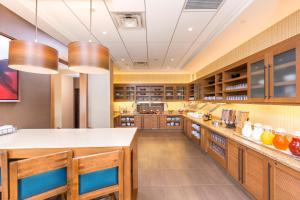 a large kitchen with wooden cabinets and counters at Hyatt Place Canton in Lake Cable
