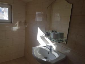 a bathroom with a sink and a mirror at Pensiunea Leo si Georgiana in Ocnele Mari +14 photos