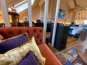 a living room with a couch and a table at The Museum - Au Lit, Jérôme! in Antwerp