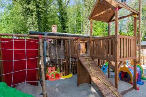 a playground with a wooden play structure with at APARTAMENTY STARE SARBINOWO in Sarbinowo
