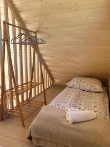 a bedroom with a bed and a spiral staircase at PAKLADA Domek całoroczny 1 in Bak