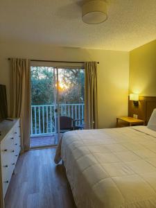 キシミーにあるKissimmee Vacation Beautiful Homeのベッドとバルコニーがあるホテルの部屋 +39枚の写真