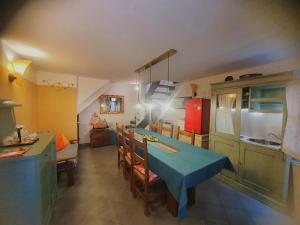 a kitchen with a blue table and chairs in a room at Ca' del Bovolo in Chioggia +12 photos