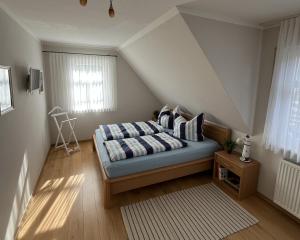 a bedroom with a bed with pillows on it at Ferienhaus Laran in Zingst
