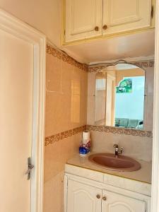 a bathroom with a sink and a mirror at Appartement Ritage in Meknès +23 photos