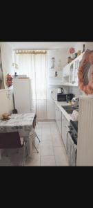 A kitchen or kitchenette at Heni Apartman