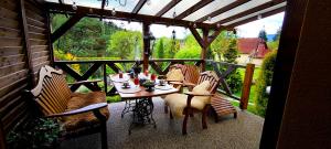 a patio with a table and chairs on a balcony at Na Divokom Vŕšku in Jamník
