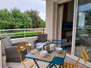 a small table and chairs on a balcony at Cap Marine in Cavalaire-sur-Mer