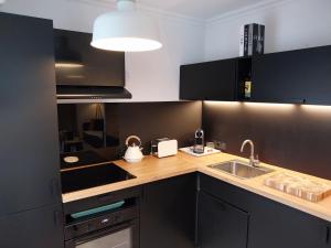 a kitchen with a sink and a counter top at Cap Marine in Cavalaire-sur-Mer +7 photos
