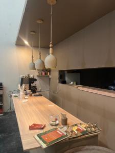 a kitchen with a wooden table in a room at A Hostel in Guadalajara