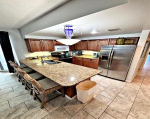 een keuken met een tafel en een roestvrijstalen koelkast bij Wyndham Ocean Walk Resort -7th Floor 2 BR Direct Oceanfront Condo 3 Balcony's in Daytona Beach