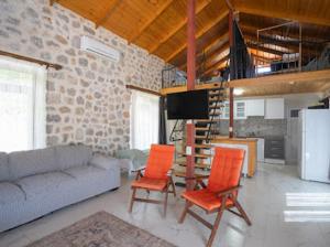 a living room with a couch and two orange chairs at Sora no mori in Marmaris