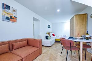 a living room with a couch and a table at New flat and central in Lisbon +25 photos