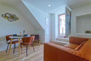 a living room with a couch and a table at New flat and central in Lisbon