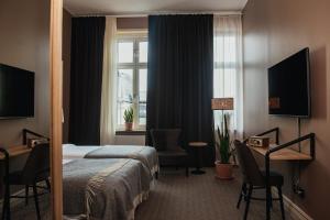 TV a/nebo společenská místnost v ubytování Home Hotel Christian IV