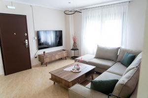 a living room with a couch and a tv at Villa Anastasia 1 in Fourka