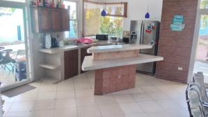 a kitchen with a sink and a refrigerator at Casa Coral in San José de Guatemala +7 photos