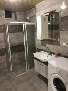 a bathroom with a shower and a toilet and a sink at VB Otel in Kumartaş +1 photo