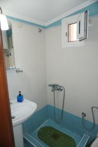 a bathroom with a sink and a shower at ELENI'S HOUSE in Nea Fokea +32 photos