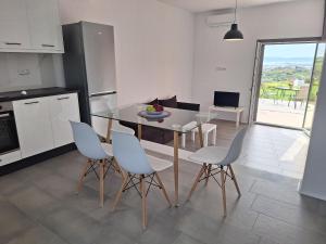 a kitchen and dining room with a table and chairs at Terracotta Sunset Naxos in Galanádhon +11 photos