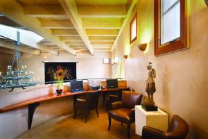 a room with two desks with chairs and a statue at El Monte Sagrado Resort & Spa in Taos