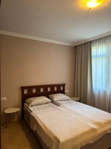 a bedroom with a large bed and a window at Santa Marina Apartment 513 in Sozopol