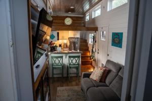 a tiny house with a kitchen and a living room at Tiny Home w Great Bay Views Pets Near Eglin Beach in Freeport