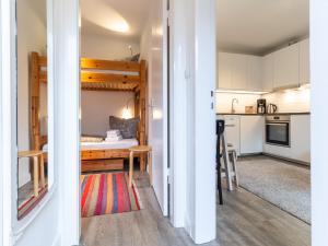 a small room with a bed and a kitchen at Ferienwohnung für 4 in Vollerwiek in Vollerwiek