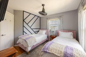 two beds sitting next to each other in a bedroom at Waterfront Home Just Minutes To Beach in Naples