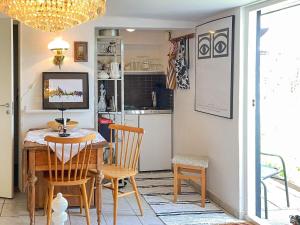 a kitchen and dining room with a table and chairs at 2 person holiday home in BORRBY in Borrby