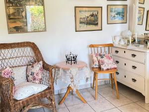 a room with wicker chairs and a table and a desk at 2 person holiday home in BORRBY in Borrby