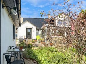 a patio with a table and chairs in front of a house at 2 person holiday home in BORRBY in Borrby
