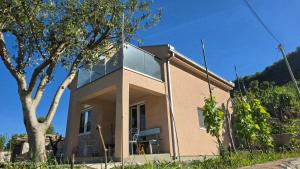 a house with a large window on the side of it at LU House in Virpazar +6 photos