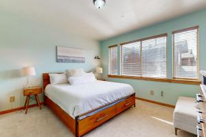 a bedroom with a bed and two windows at Truckee Living in Truckee +21 photos