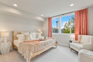 a bedroom with a bed and a chair and a window at Perch - Wanderlusts Hidden Gem in Seattle