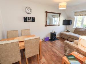 a living room with a table and a couch at Tree Tops View in Windermere