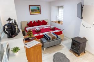 a small room with a bed and a stove at Guest House Lejla in Travnik