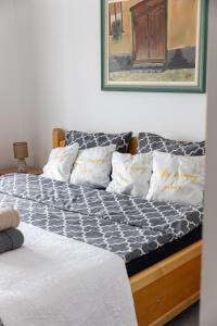a bed with a black and white comforter and pillows at Guest House Lejla in Travnik +90 photos