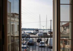 a view from a window of a parking lot with cars at Scalo del Mare Apartment in Keramoti