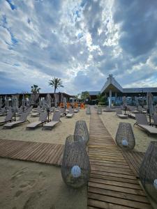 a row of lounge chairs on a sandy beach at Grand Sapphire Casino 1 bdr 002 in Iskele +107 photos