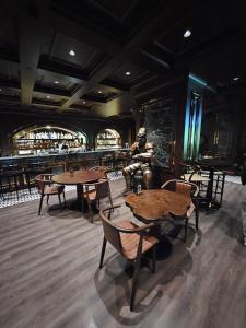 a restaurant with tables and chairs and a bar at Grand Sapphire Casino 1 bdr 002 in Iskele