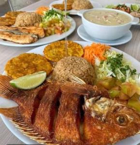 a table with several plates of food on it at Safio. Una casa en el paraiso. in Nuquí