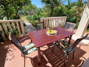 a wooden table and chairs on a patio at Apartments Kadenca in Omiš