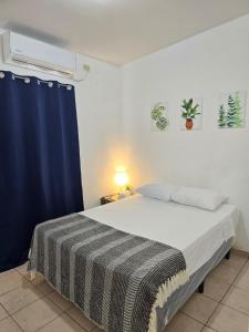 a bedroom with a bed with a blue curtain at Tu espacio ideal in San Miguel +20 photos