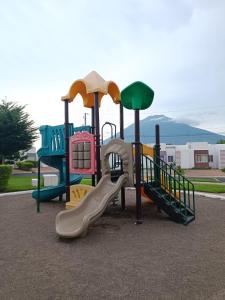 a playground with a slide in a park at Tu espacio ideal in San Miguel