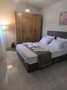 a bedroom with a large bed with white pillows at Araucaria studio Manis in Mesochórion