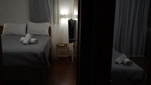 een kleine slaapkamer met 2 bedden en een televisie bij Villa Astravi in Ialyssos