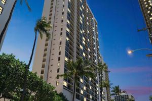 a tall building with palm trees in front of it at Oceanview 30th Floor Condo Just Steps from Waikiki Beach, Full Kitchen, Free Parking (13007) in Honolulu